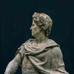 Close-up of a marble statue depicting a classical historical figure with intricate details.