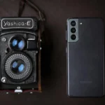 A vintage Yashica camera next to a modern smartphone, showcasing old and new technology.